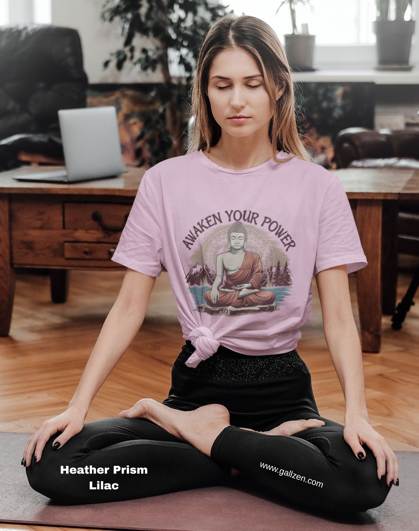A person meditating in a home setting, wearing a light pink t-shirt with a serene graphic that promotes inner peace.