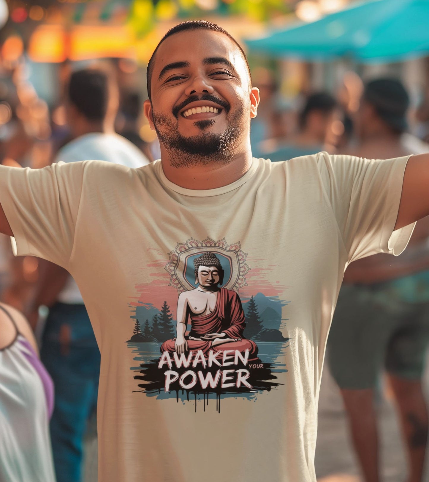 Man wearing a t-shirt with a Buddha graphic and 'Awaken Your Power' text in a crowded outdoor setting.