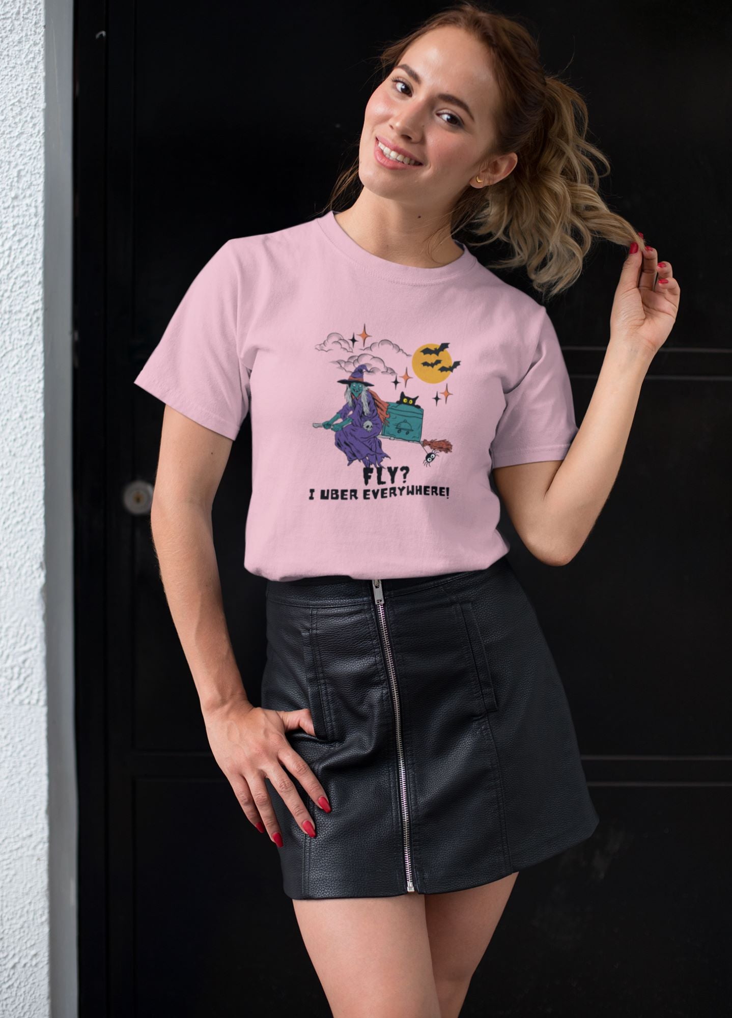 Attractive-young-woman-posing-on-a-playful-witch-themed-graphic-pink-tee-for-Halloween