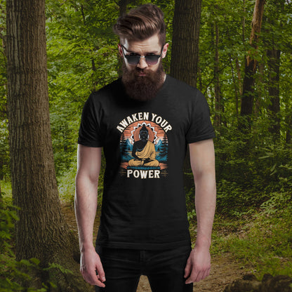 Man wearing a black t-shirt with 'Awaken Your Power' design in a forest setting