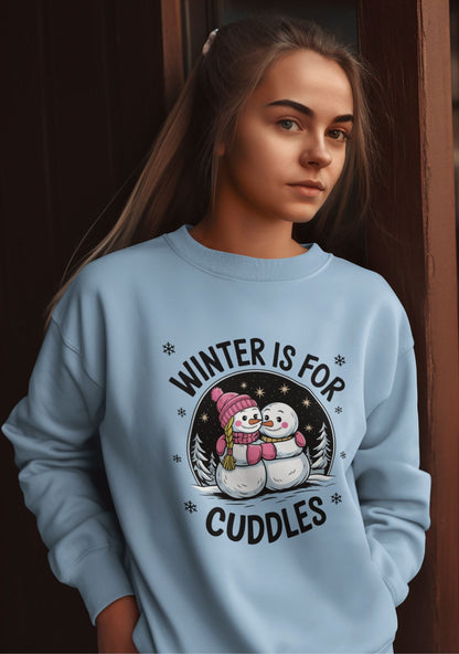 Casual-winter-sweatshirt-with-snowman-cuddle-design-worn-by-a-young-woman-leaning-against-a-wooden-door