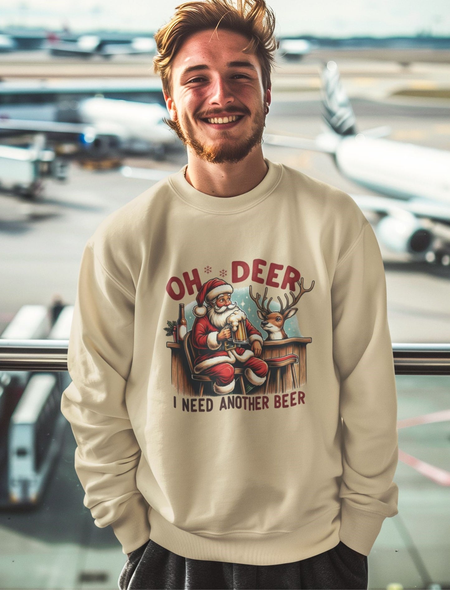 Cheerful-man-smiling-in-an-airport-lounge-wearing-a-festive-Christmas-sweatshirt-with-Santa-and-reindeer-enjoying-beer