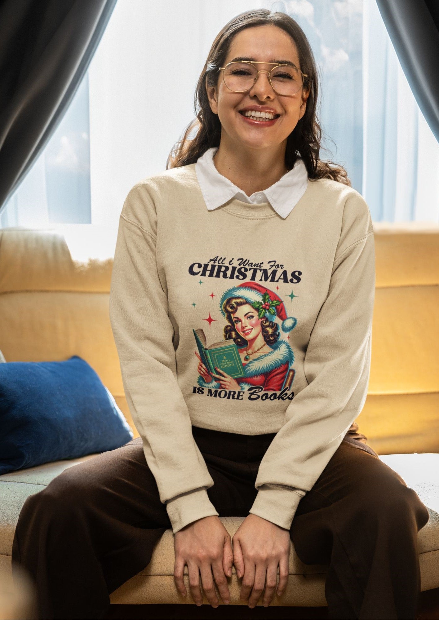 Cheerful-woman-sitting-on-a-couch-wearing-a-beige-Christmas-sweatshirt-with-text-promoting-books-as-gifts