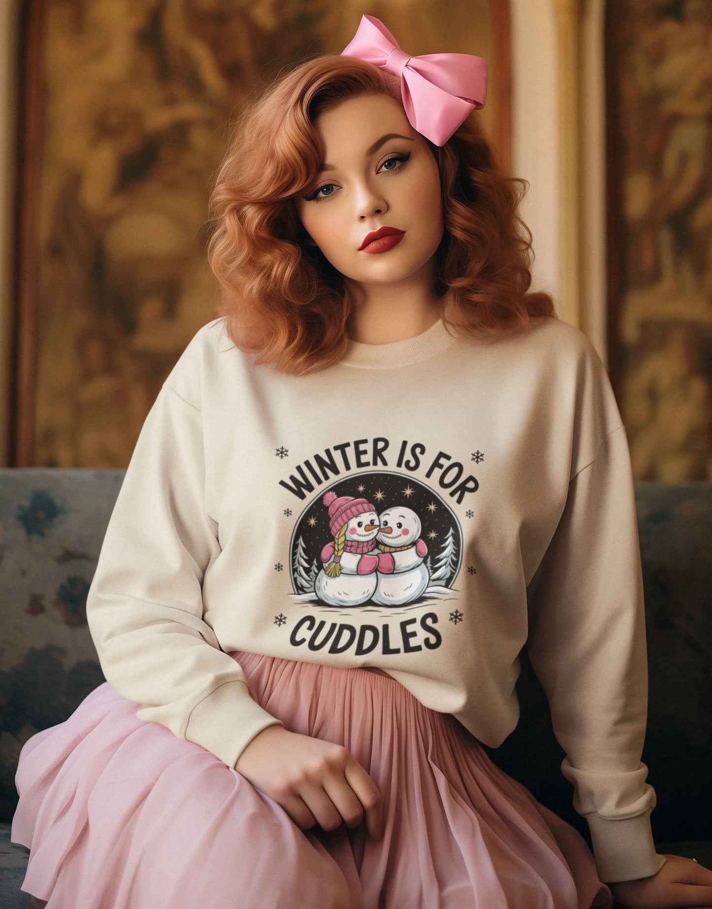 Coquette-style-woman-with-red-curls-a-large-pink-bow-and-a-cream-sweatshirt-with-the-text-Winter-is-for-Cuddles