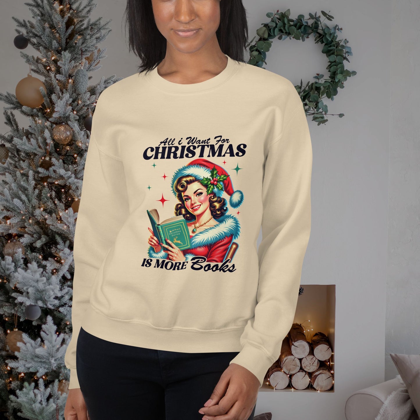 Cozy-holiday-scene-featuring-a-woman-wearing-a-cream-sweatshirt-with-All-I-Want-for-Christmas-is-More-Books-design-posed-near-a-fireplace-and-Christmas-tree