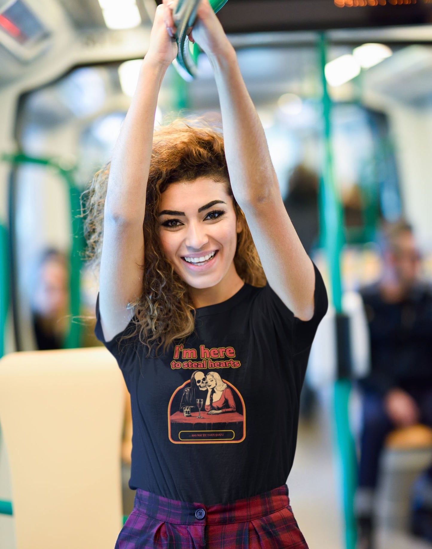 Delightful-young-lady-wearing-a-black-graphic-t-shirt-that-declares-I-m-here-to-steal-hearts