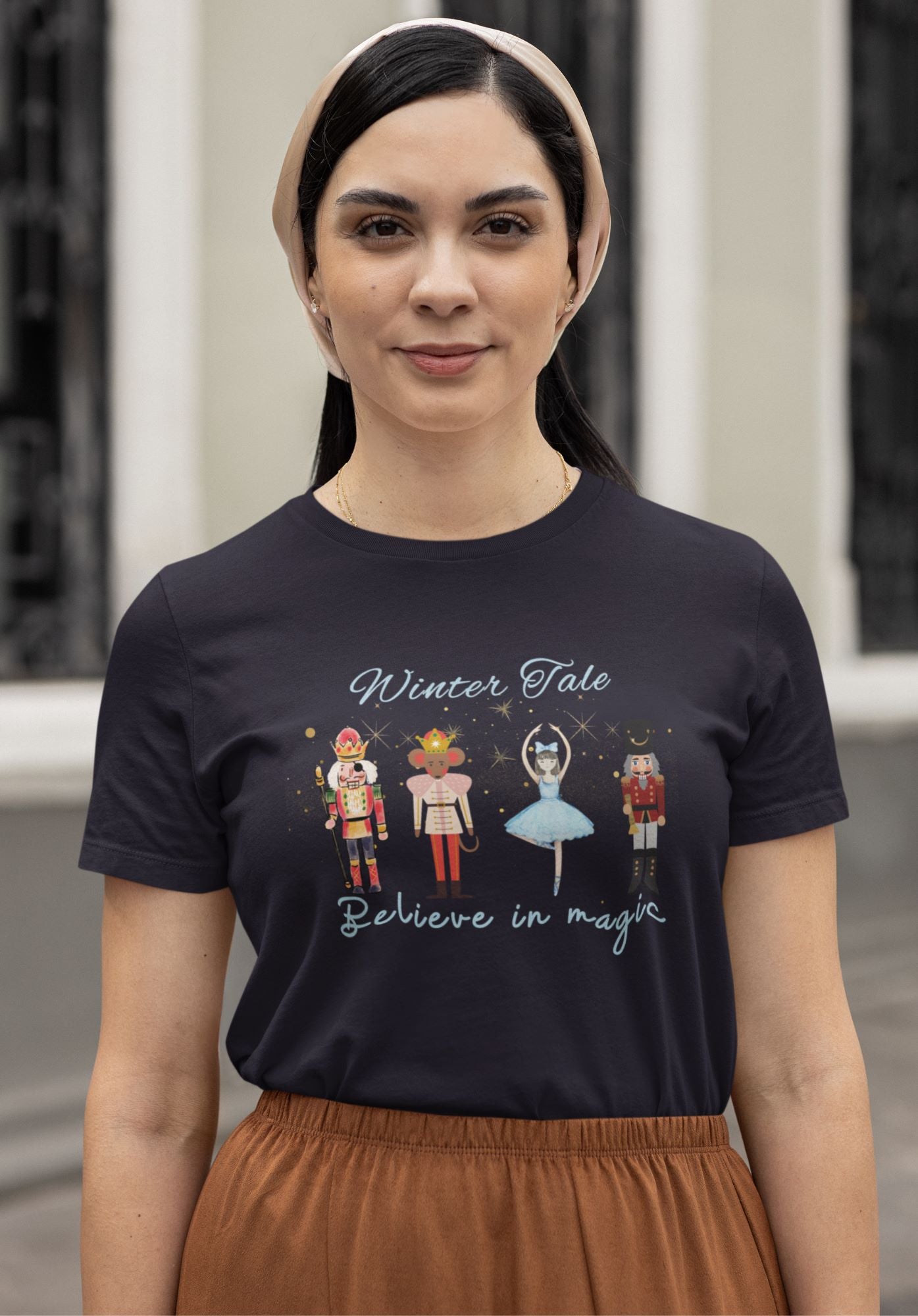 Fashionable-winter-themed-navy-t-shirt-worn-by-a-woman-showcasing-a-unique-Nutcracker-design-ideal-for-festive-occasions