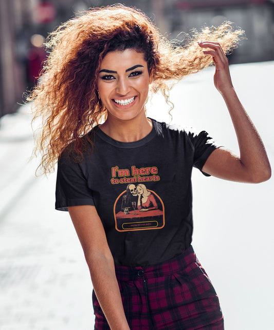 Joyful-young-woman-with-curly-hair-smiles-brightly-in-a-cheeky-skeleton-graphic-tee-blending-chic-and-charm-on-a-sunny-day