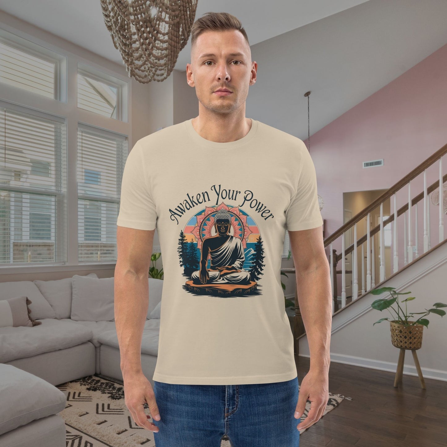 Man wearing a t-shirt with a Buddha graphic and 'Awaken Your Power' text in a living room.