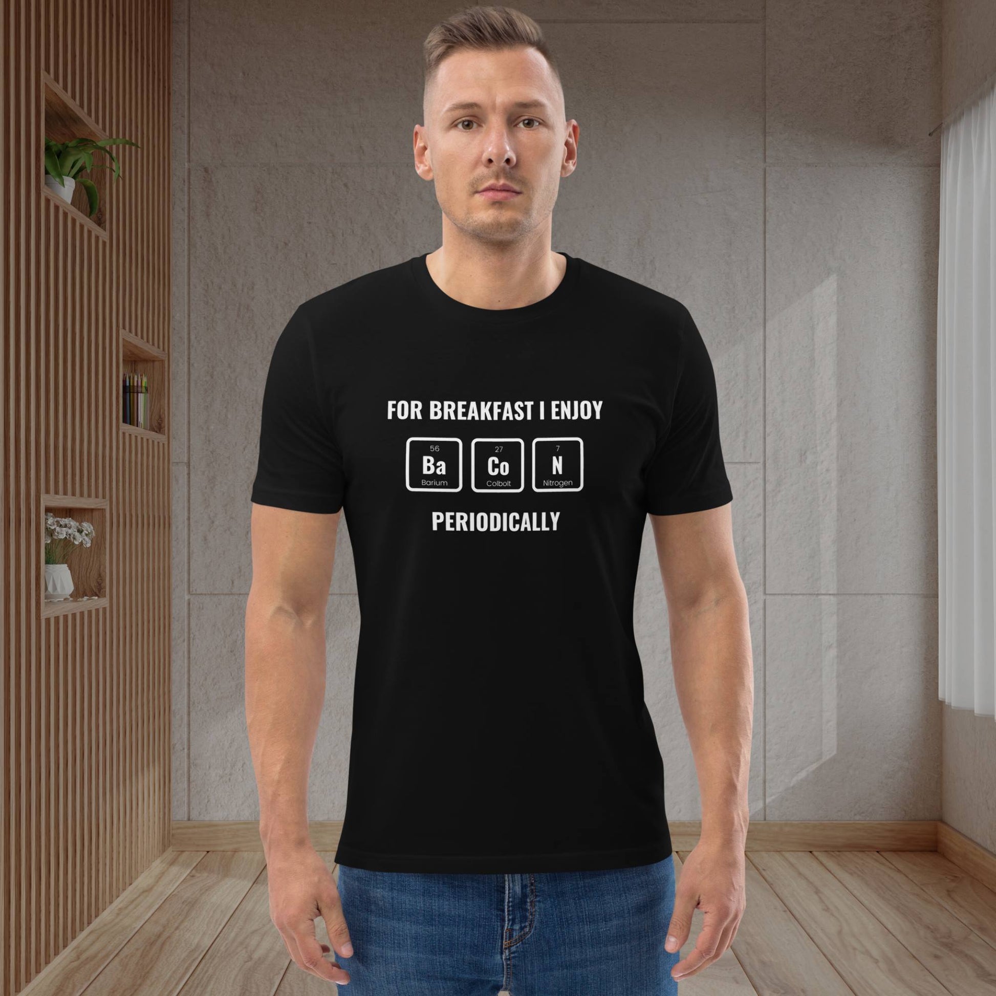 Man-in-casual-attire-jeans-wearing-a-black-T-shirt-with-a-funny-breakfast-and-periodic-table-design