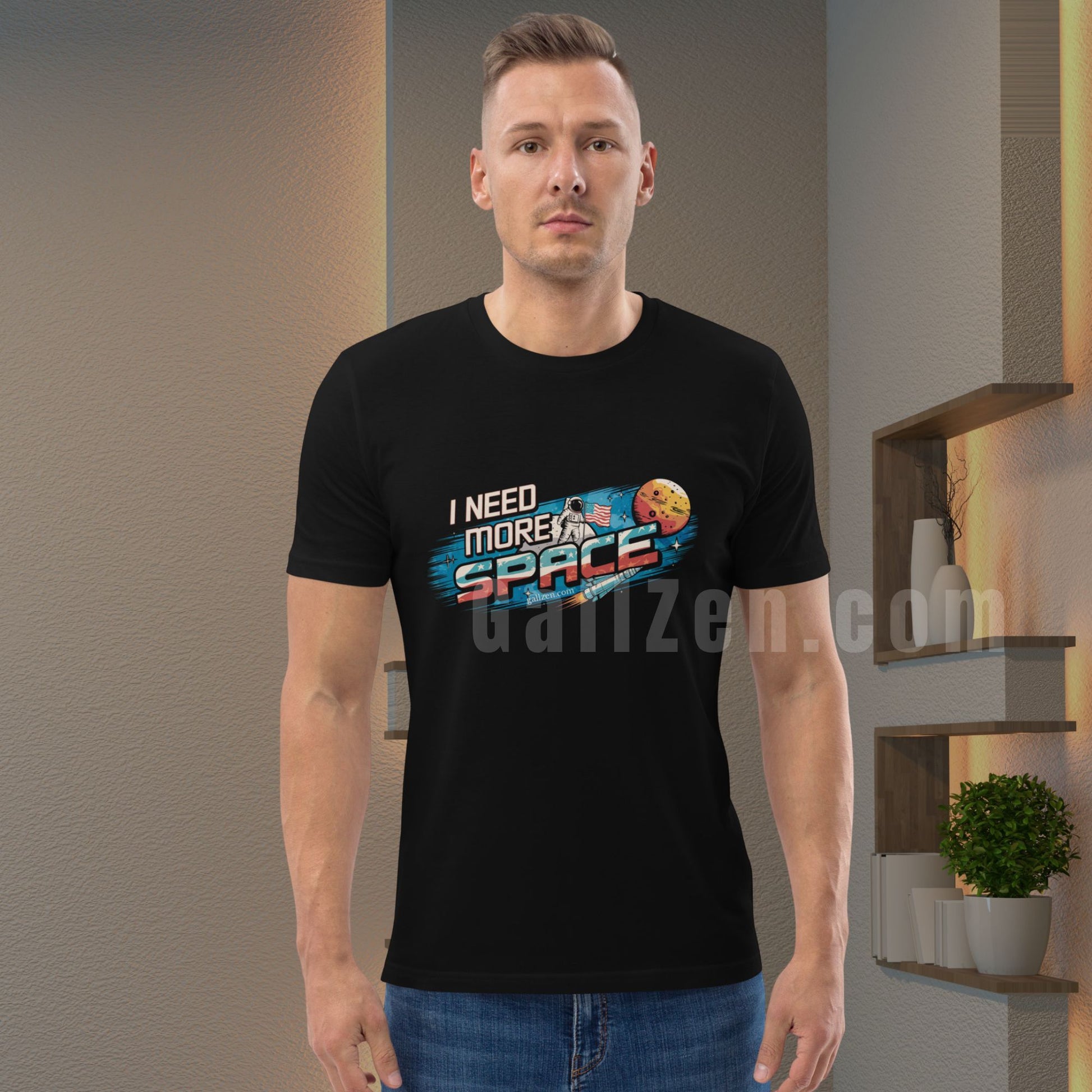 Man-posing-in-a-black-t-shirt-featuring-a-vintage-astronaut-and-retro-space-design-standing-against-a-modern-interior-with-warm-lighting