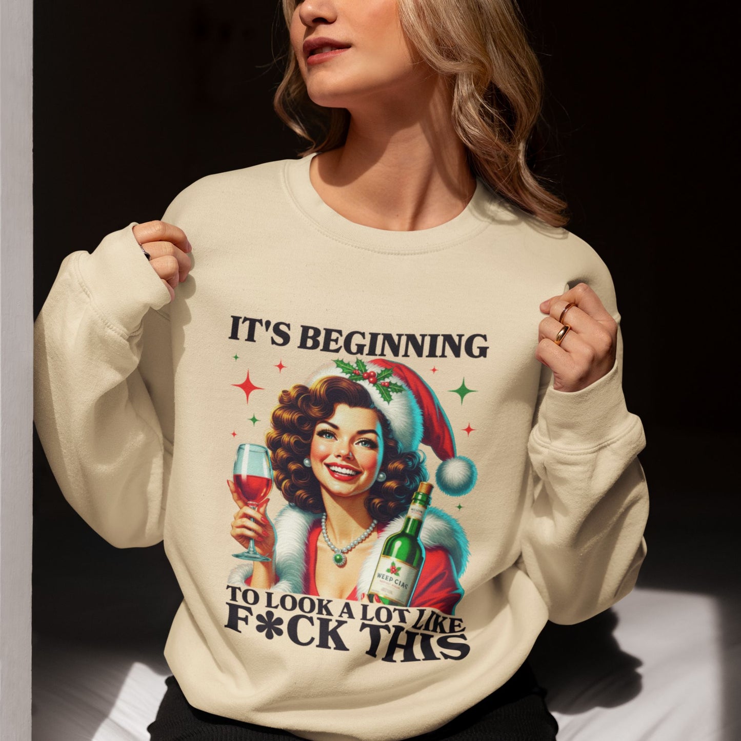 Mockup-of-a-young-woman-standing-near-a-window-wearing-a-beige-Christmas-themed-sweatshirt-with-retro-artwork-basking-in-soft-sunlight