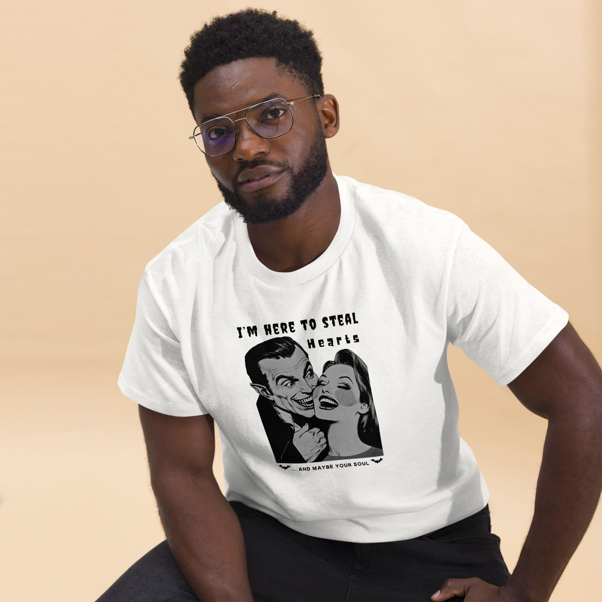 Portrait-of-a-man-in-a-white-tee-printed-with-a-classic-horror-movie-scene-and-a-quirky-quote-about-stealing-hearts