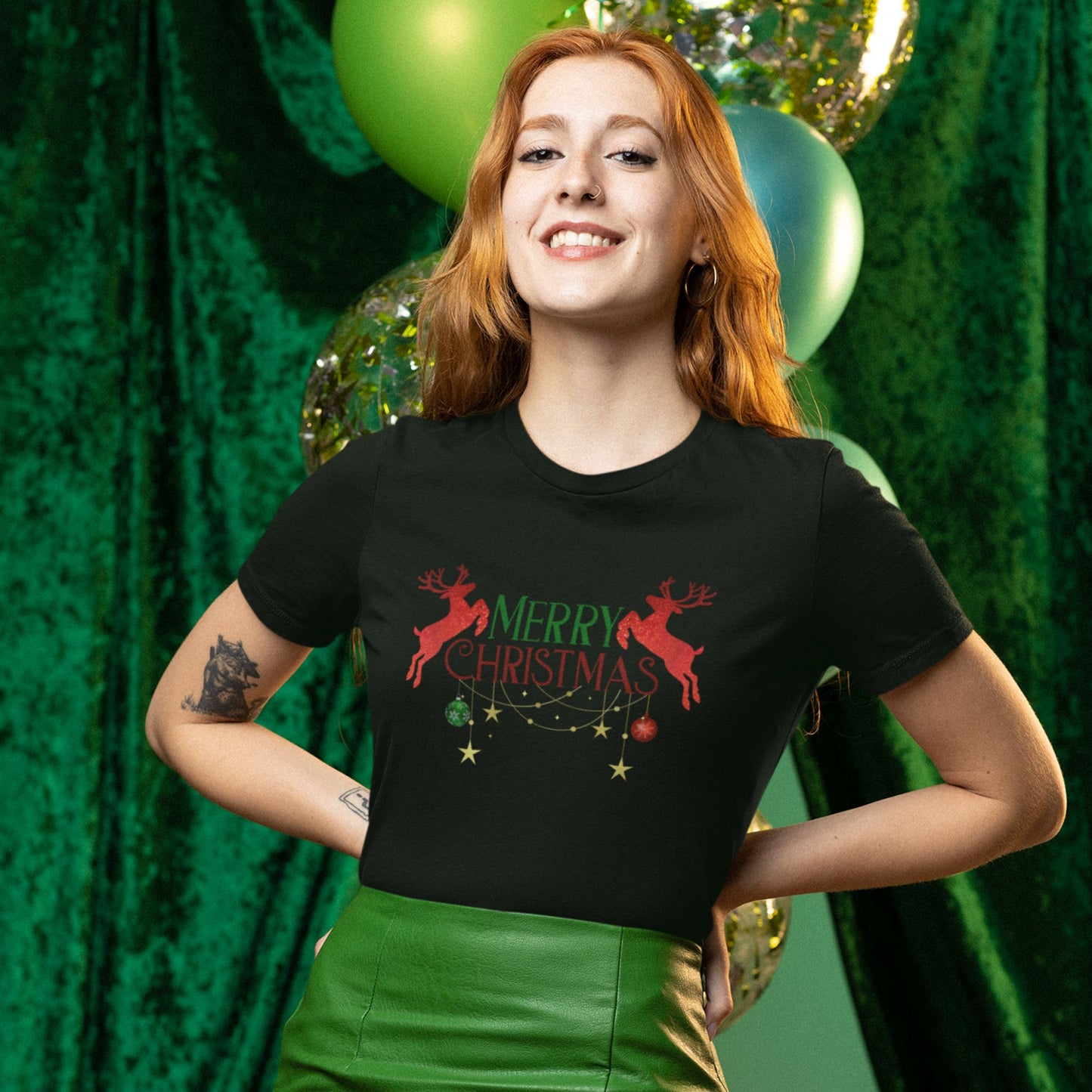 Red-haired-woman-wearing-a-casual-Christmas-outfit-featuring-a-black-tee-with-holiday-graphics