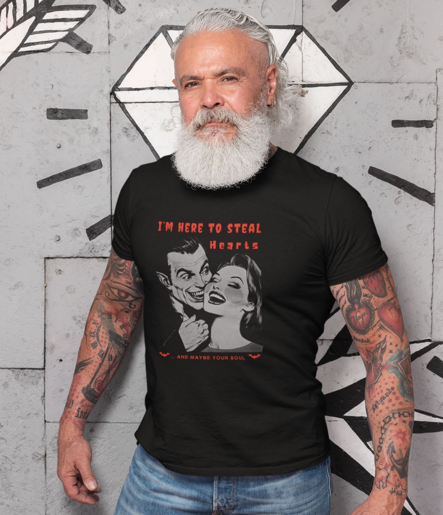 Senior-tattooed-male-model-posing-in-a-Halloween-t-shirt-featuring-a-vampire-and-a-woman