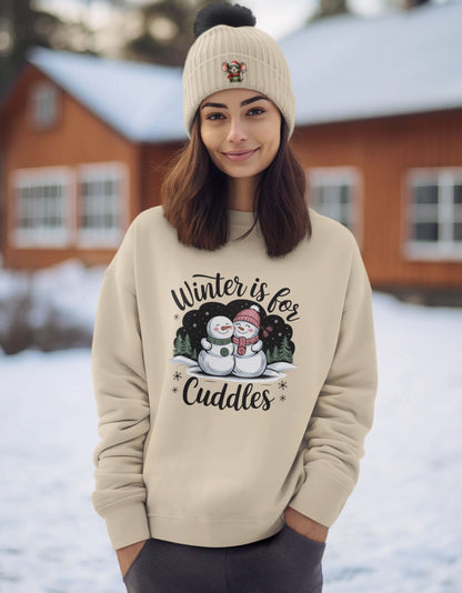 Smiling-woman-outdoors-in-winter-attire-wearing-a-beige-sweatshirt-with-Winter-is-for-Cuddles-graphic-and-matching-beanie