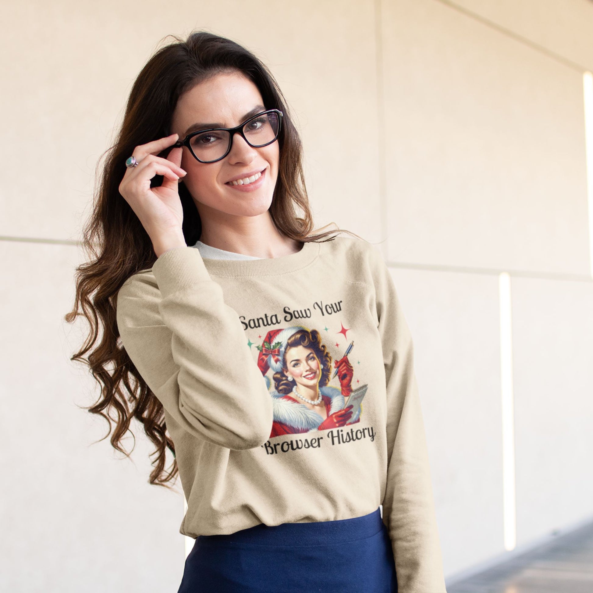 Smiling-woman-with-glasses-modeling-a-light-beige-crewneck-sweater-with-vintage-Christmas-art-and-text-indoors