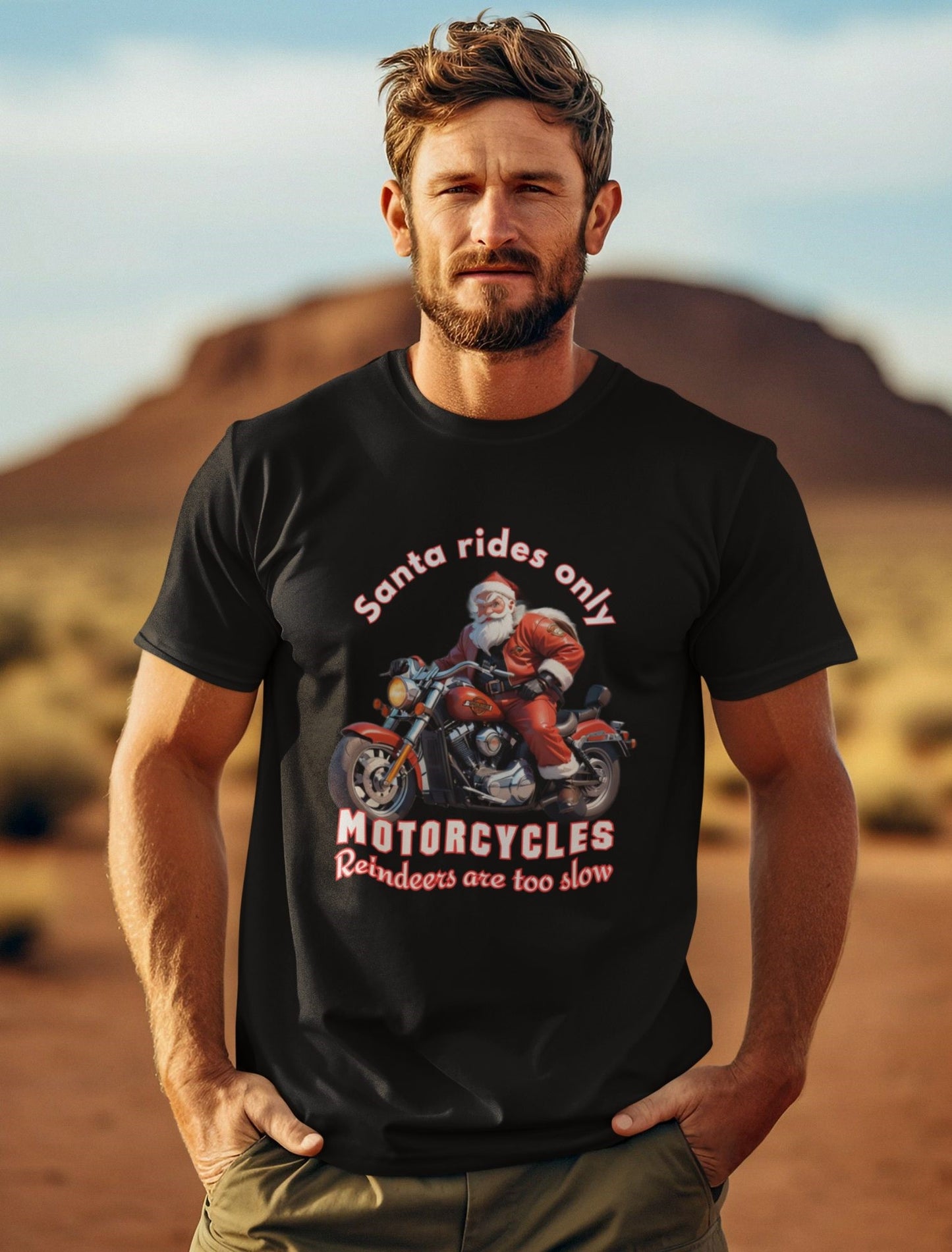 Stylish-holiday-outfit-with-a-Santa-rides-motorcycle-t-shirt-worn-by-a-man-with-a-cinematic-look-and-mountain-background