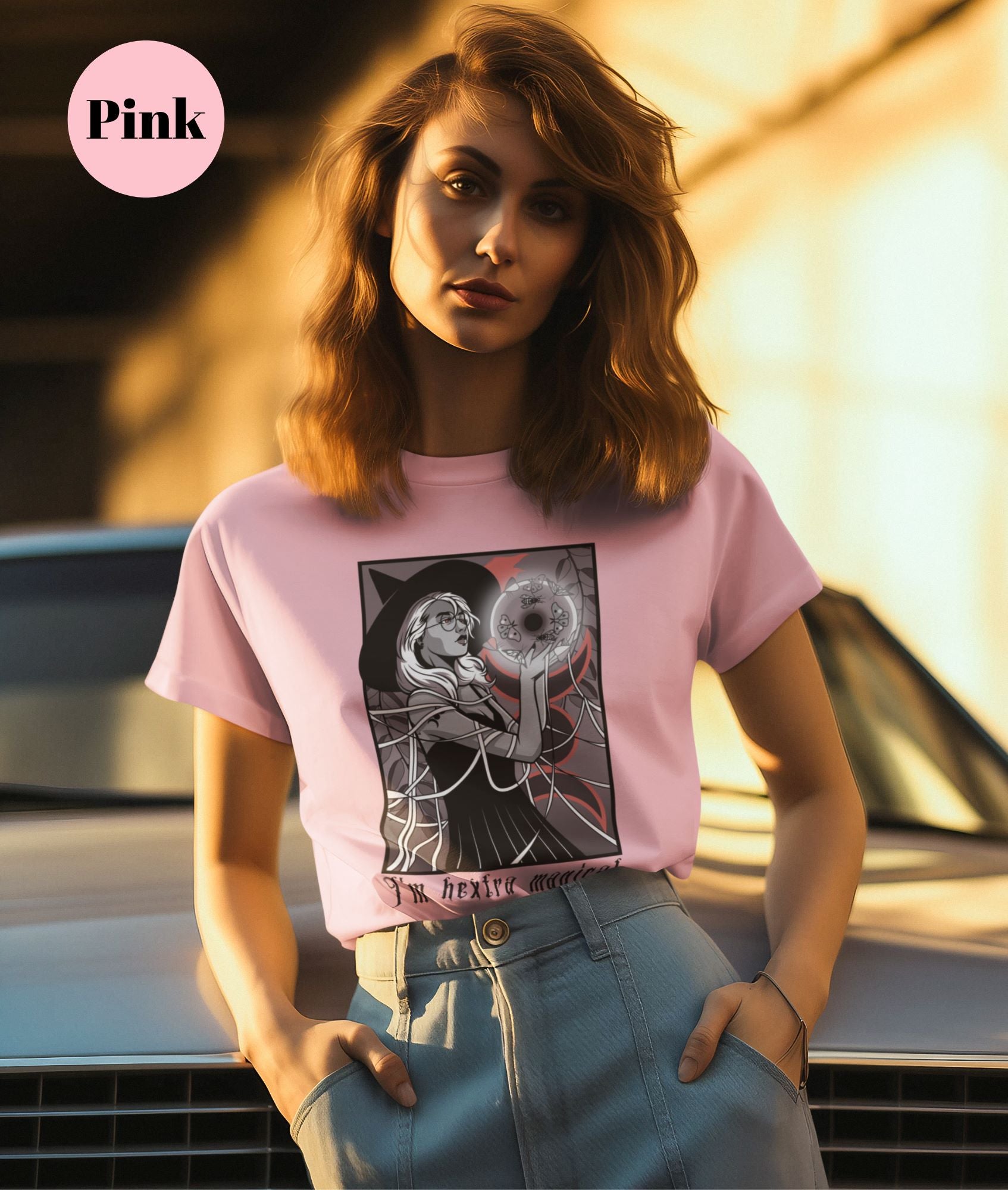 T-shirt-mockup-of-a-woman-in-high-waisted-pants-and-a-pink-witch-themed-tee-standing-next-to-a-vintage-car