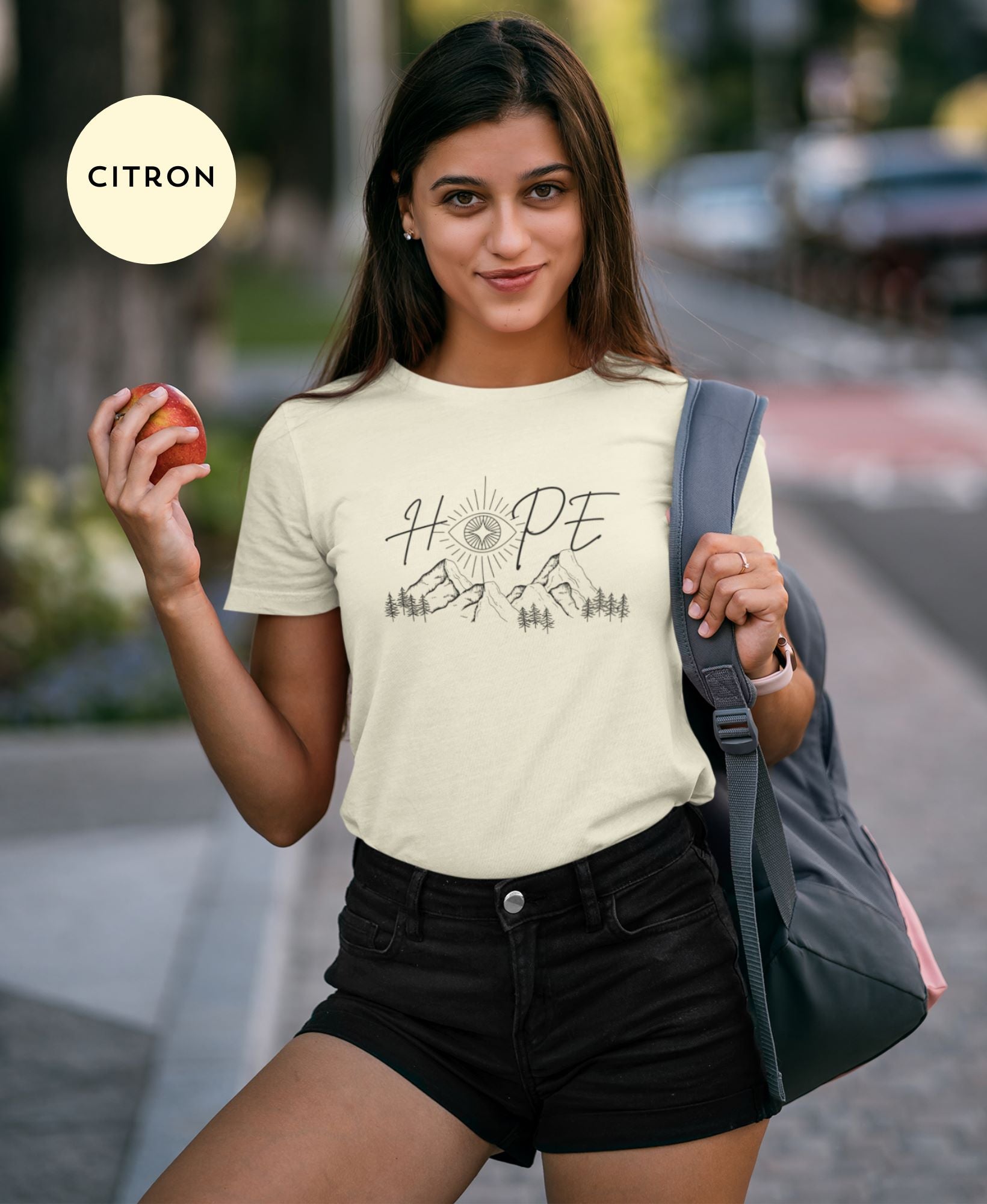 Urban-chic-look-of-young-woman-in-Citron-t-shirt-and-black-high-waisted-shorts-smiling-brightly