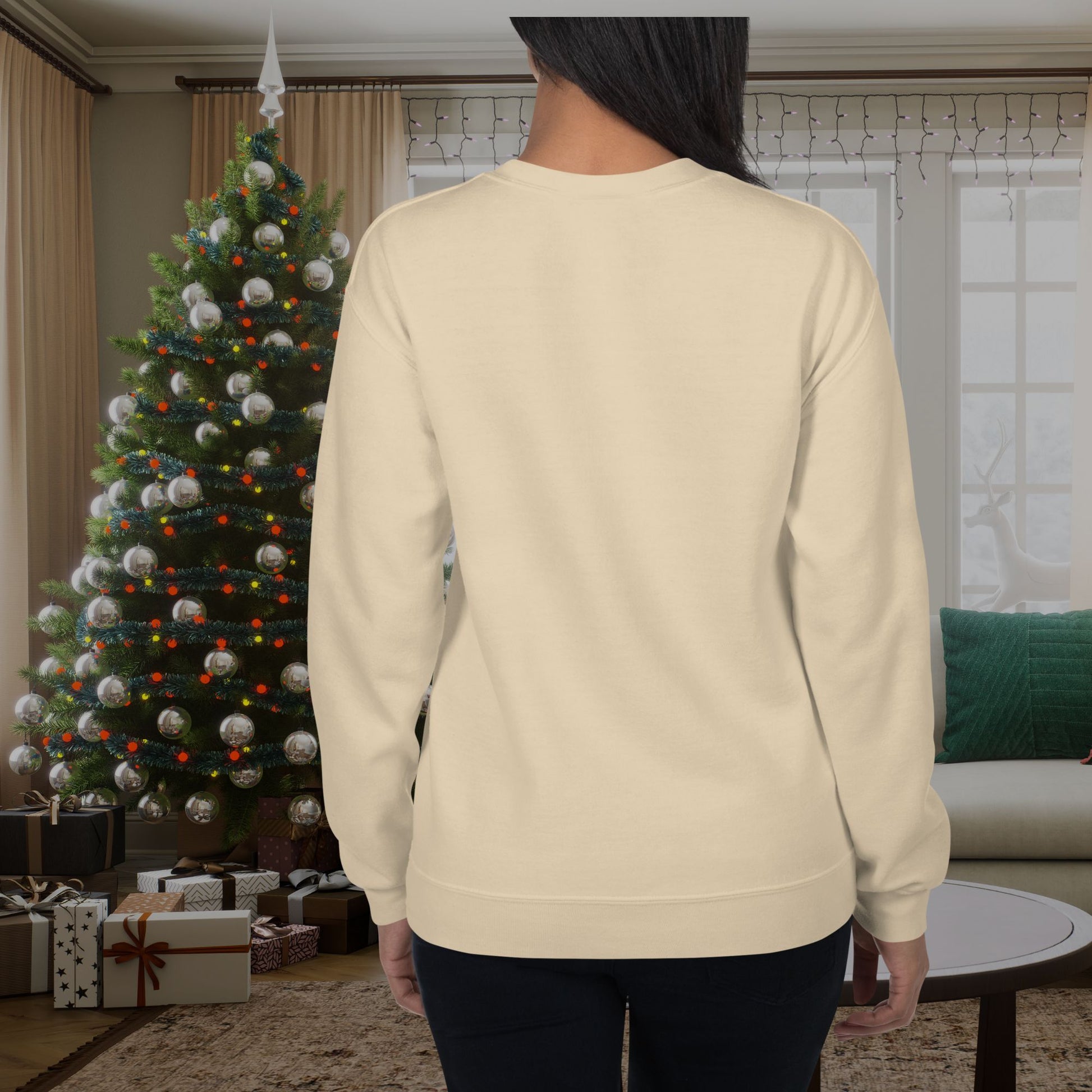 Woman-posing-in-a-beige-sweater-standing-near-a-Christmas-tree-and-festive-decor