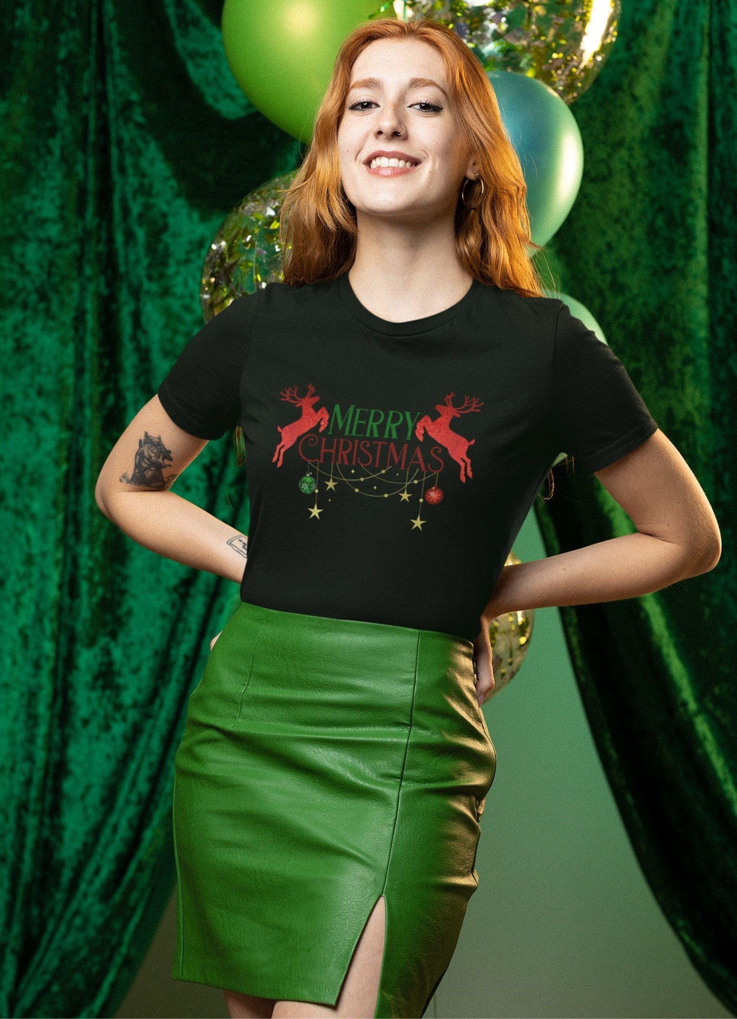 a-red-haired-happy-woman-a-posing-on-a-black-Merry-Christmas-themed-t-shirt-with-red-glitter-reindeers-graphic