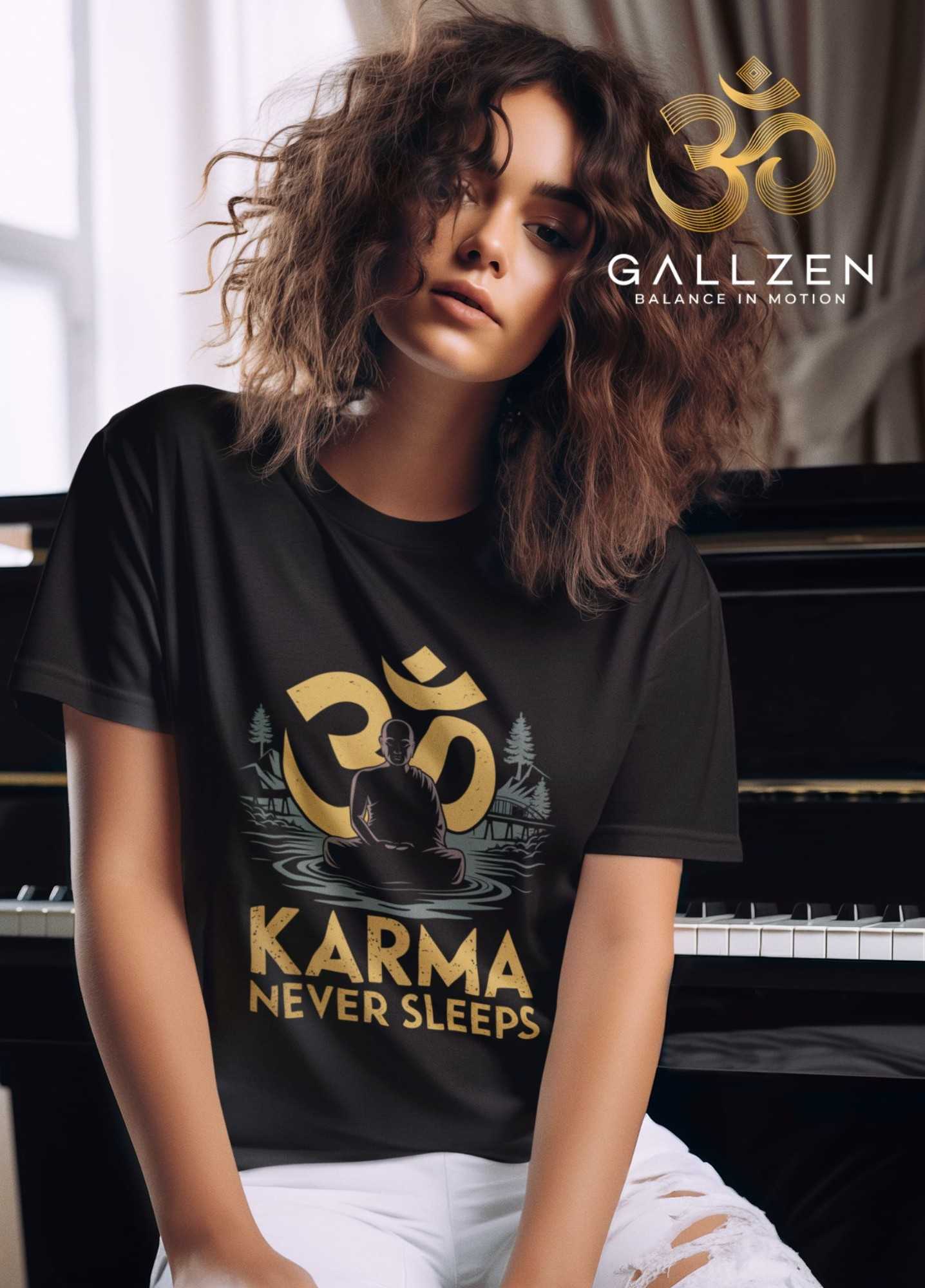 A woman wearing a black graphic t-shirt with a gold Om symbol and the text 'KARMA NEVER SLEEPS' sits in front of a piano. 