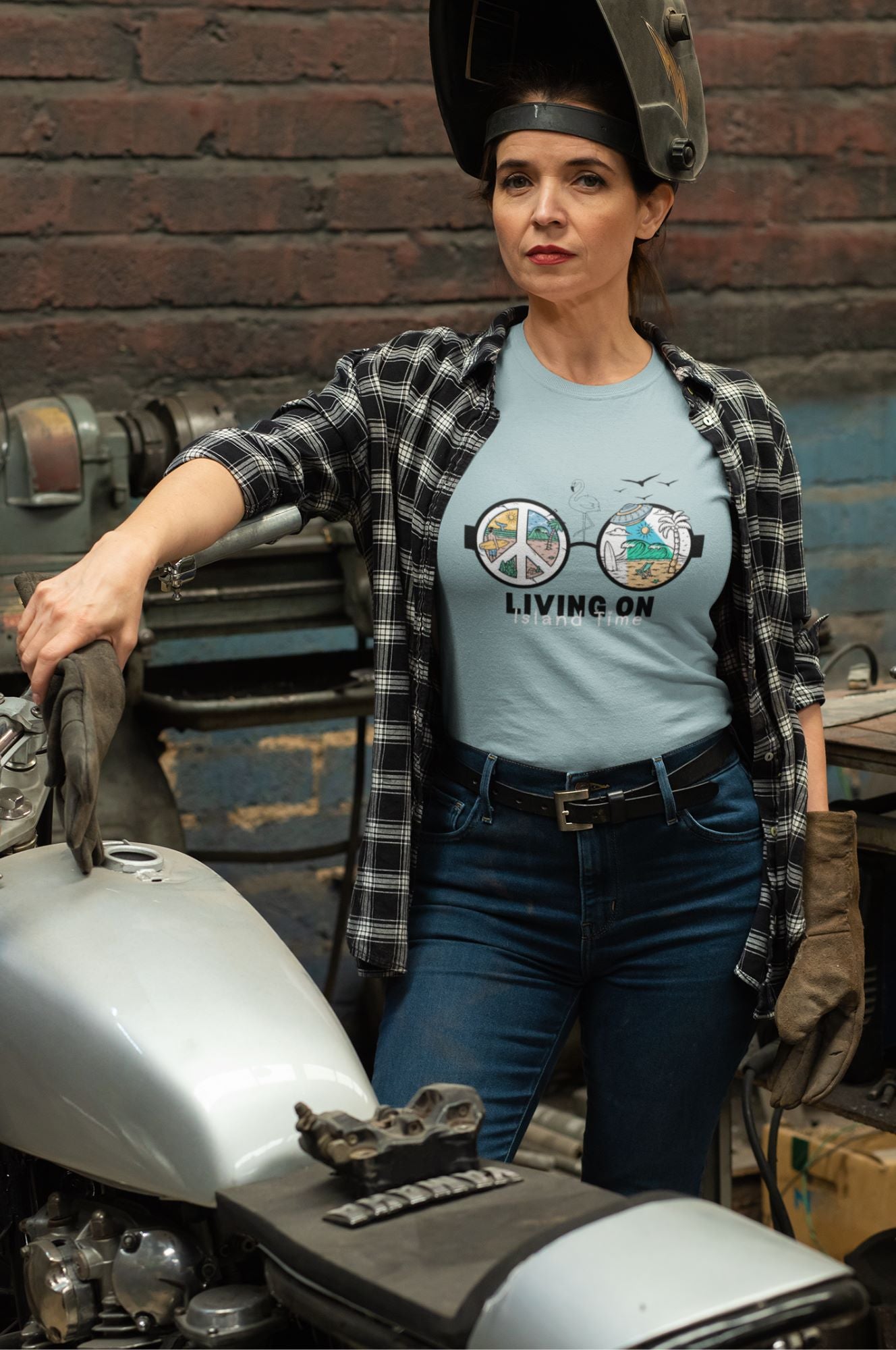 blue-lagoon-t-shirt-mockup-featuring-a-woman-repairing-a-american-motorcycle-in-her-garage