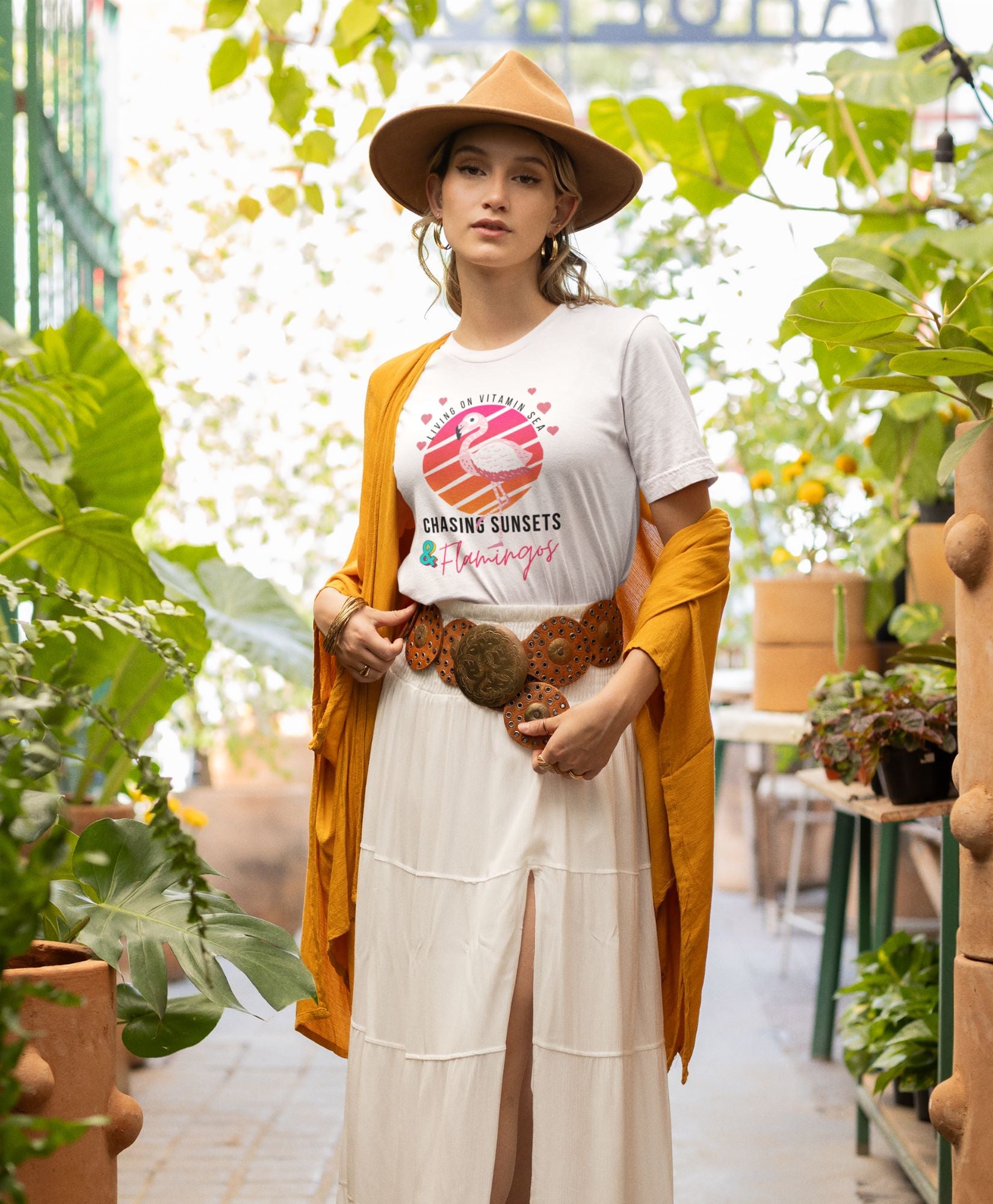 boho-inspired-mockup-featuring-a-woman-wearing-a-white-tee-printed-with-a-flamingo-on-the-beach