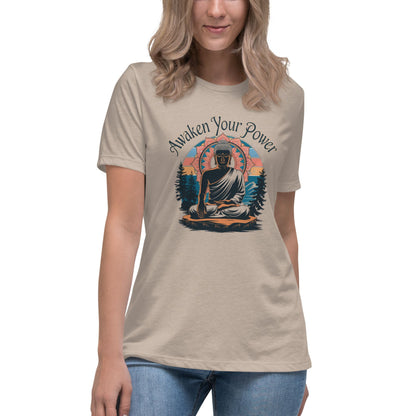  A comfortable, relaxed-fit t-shirt in light beige, featuring a graphic print of a meditating Buddha, surrounded by a serene landscape and a colorful mandala, with the inspiring message "Awaken Your Power," perfect for embodying spiritual awakening and inner strength.