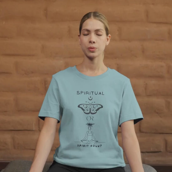 Video-Of-A-Woman-Meditating-In-Blue-Lagoon-T-Shirt-With-A-Butterfly-Graphic-And-A-Meditating-Figure-Asking-Spiritual-Or-Spirit-Down