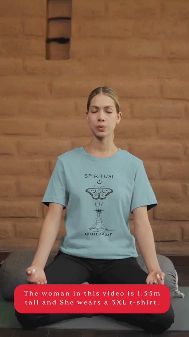 Video-Of-A-Woman-Meditating-In-Blue-Lagoon-T-Shirt-With-A-Butterfly-Graphic-And-A-Meditating-Figure-Asking-Spiritual-Or-Spirit-Down