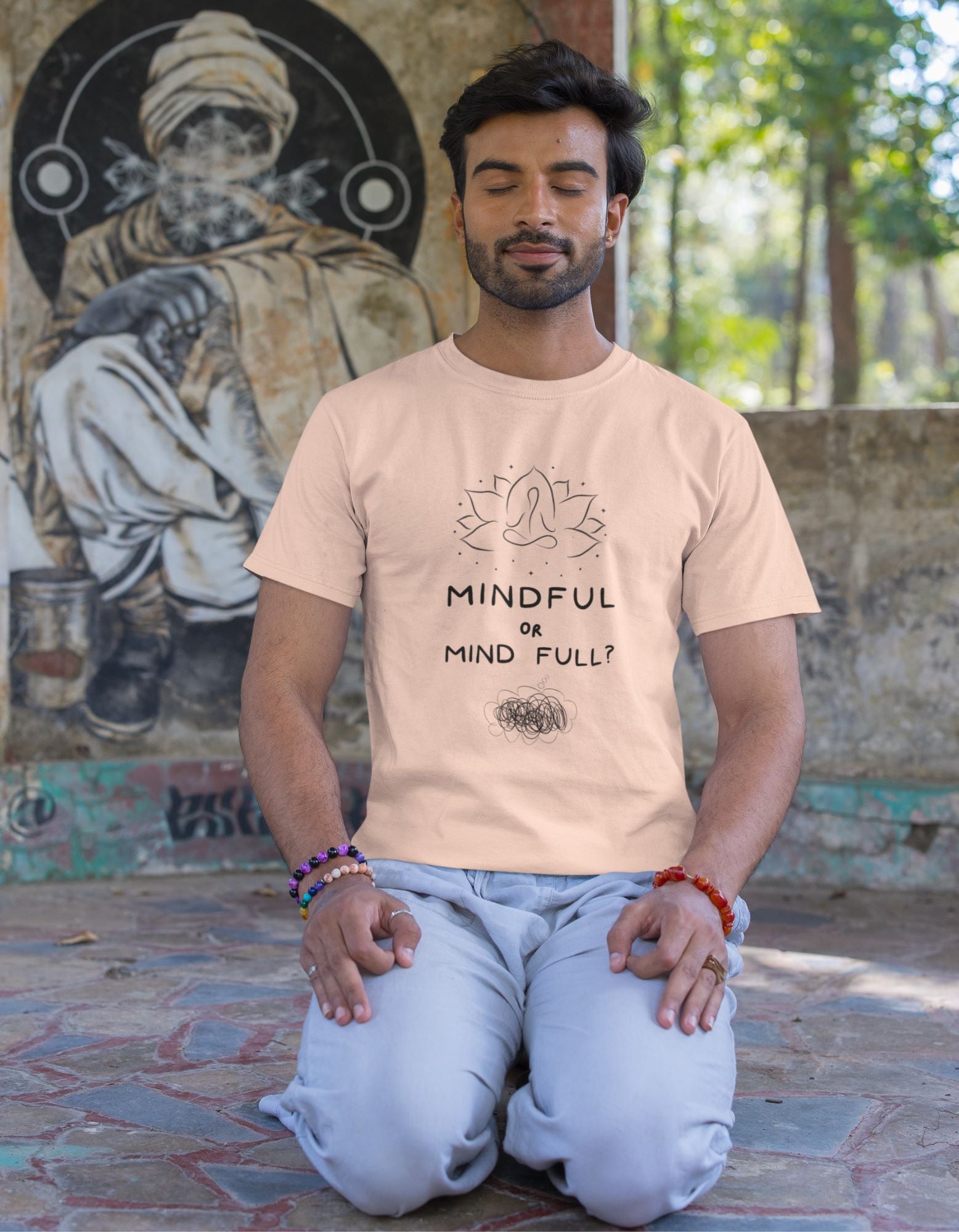 round-neck-tee-mockup-of-a-bearded-man-meditating-next-to-a-wall-with-graffiti