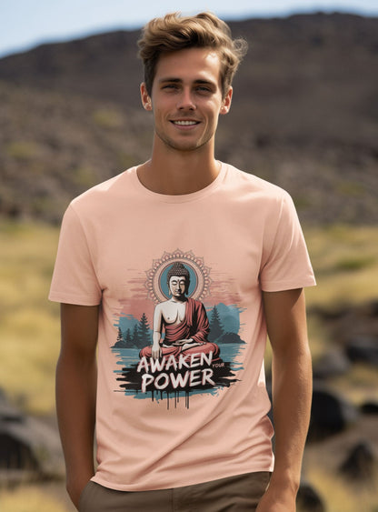 Man wearing a pink t-shirt with a Buddha graphic and 'Awaken Power' text in a natural setting.