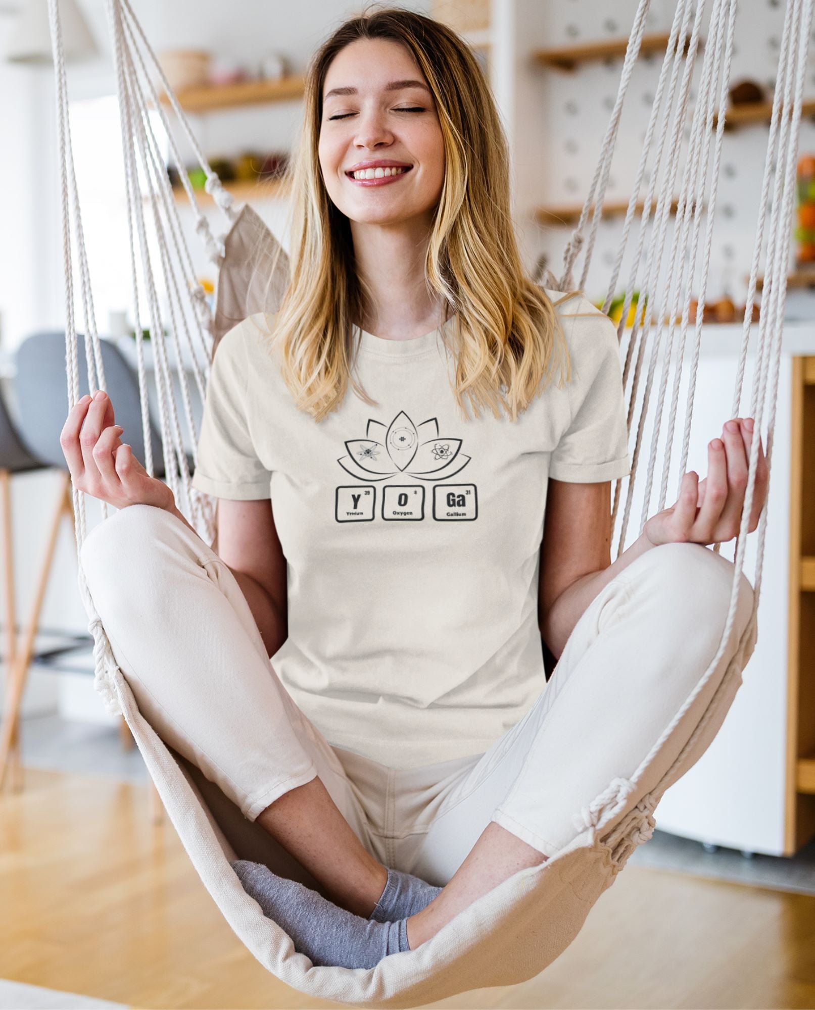 t-shirt-mockup-of-a-smiling-woman-meditating-on-a-hammock-at-home-in-living-room