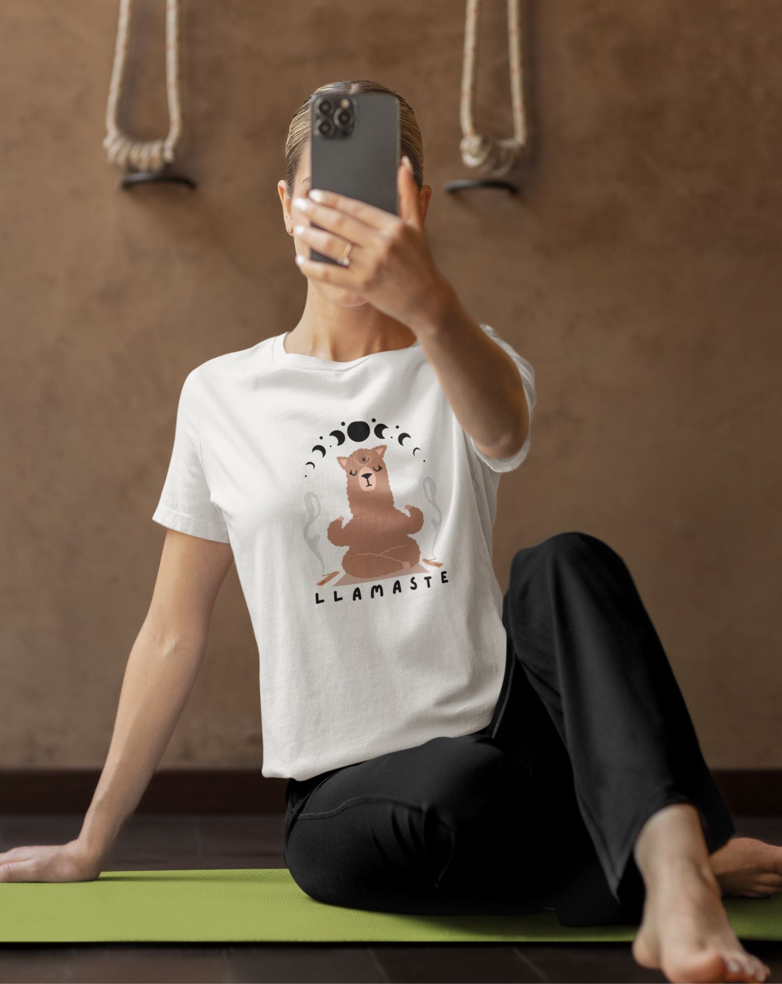 tee-mockup-of-a-42-years-old-woman-yoga-instructor-taking-a-selfie-with-her-iphone