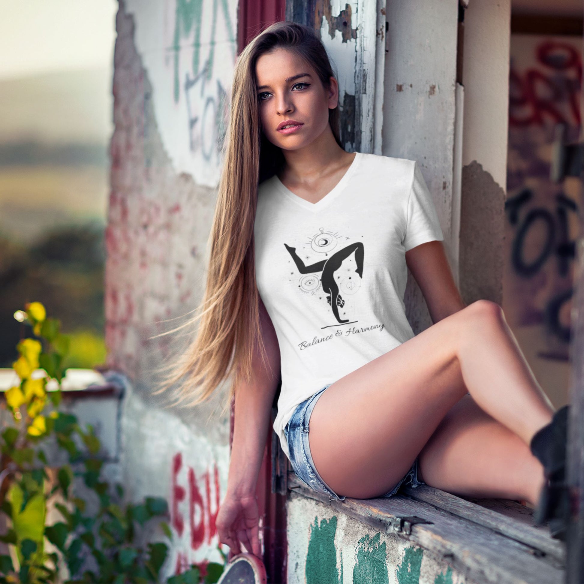 v-neck-tee-mockup-of-a-woman-sitting-on-the-window-in-an-abandoned-building