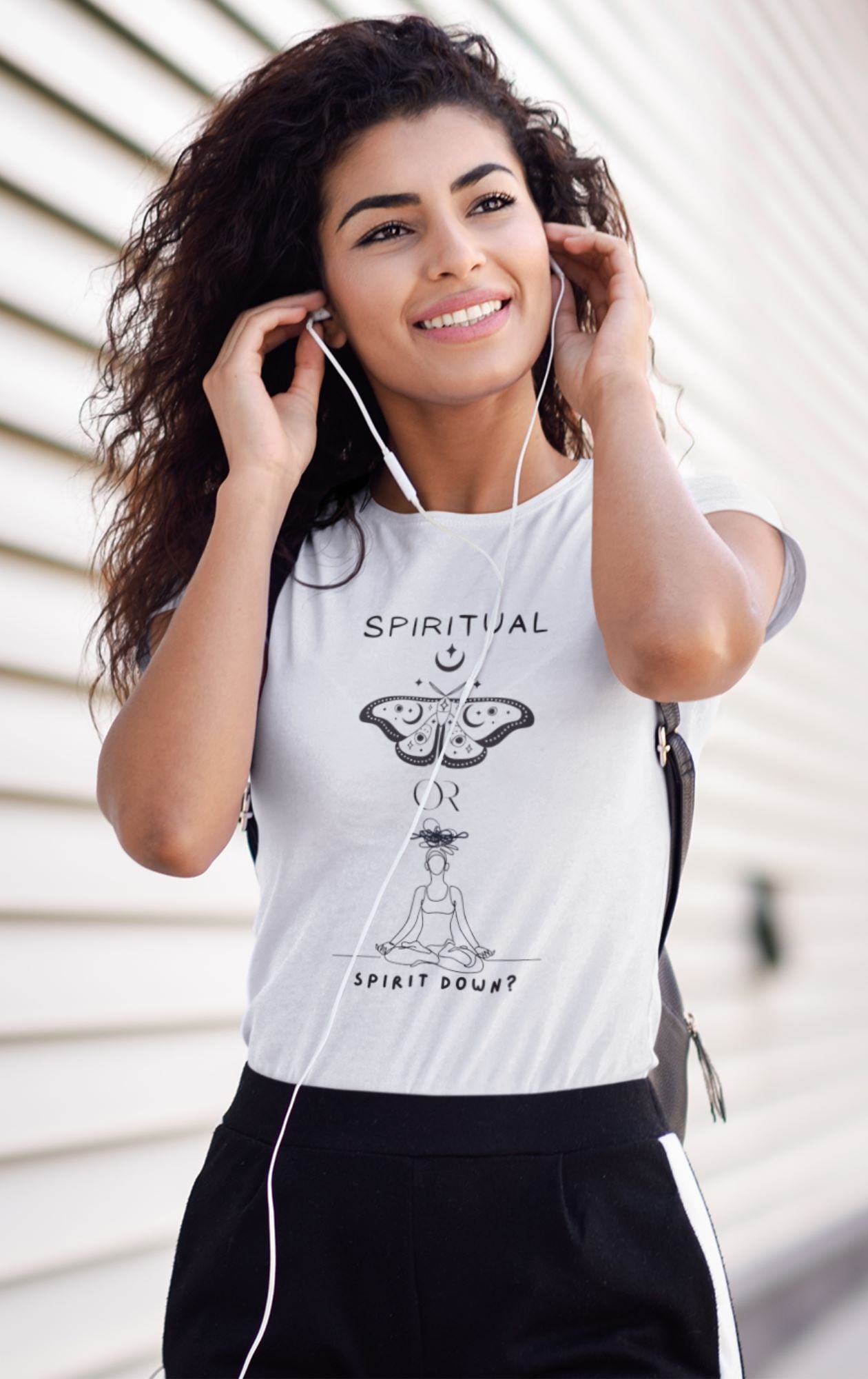 white-t-shirt-mockup-of-a-young-woman-with-curly-hair-putting-on-headphones