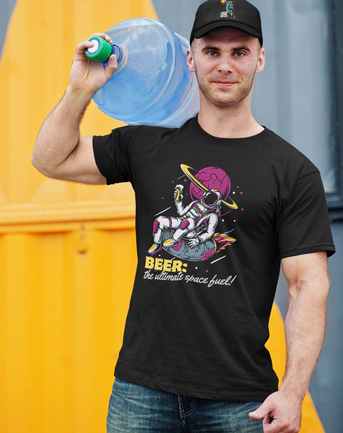 working-man-who-delivers-water-dressed-in-quirky-black-tee-featuring-astronaut-and-beer-motif-complemented-by-jeans