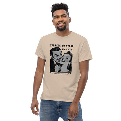 young-man-posing-in-a-casual-outfit-with-a-beige-t-shirt-with-a-black-and-white-Dracula-print-saying-I-m-here-to-steal-hearts-and-maybe-your-s