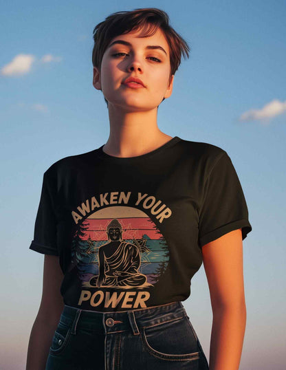 Person wearing a black t-shirt with 'Awaken Your Power' design against a blue sky.